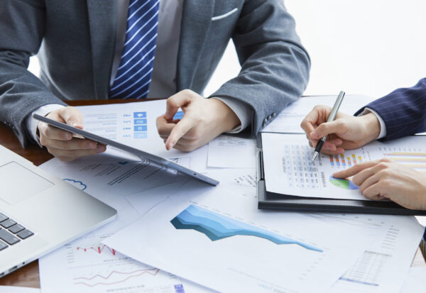 Two businessmen in elegant suits at a business meeting discussing a new project in the office